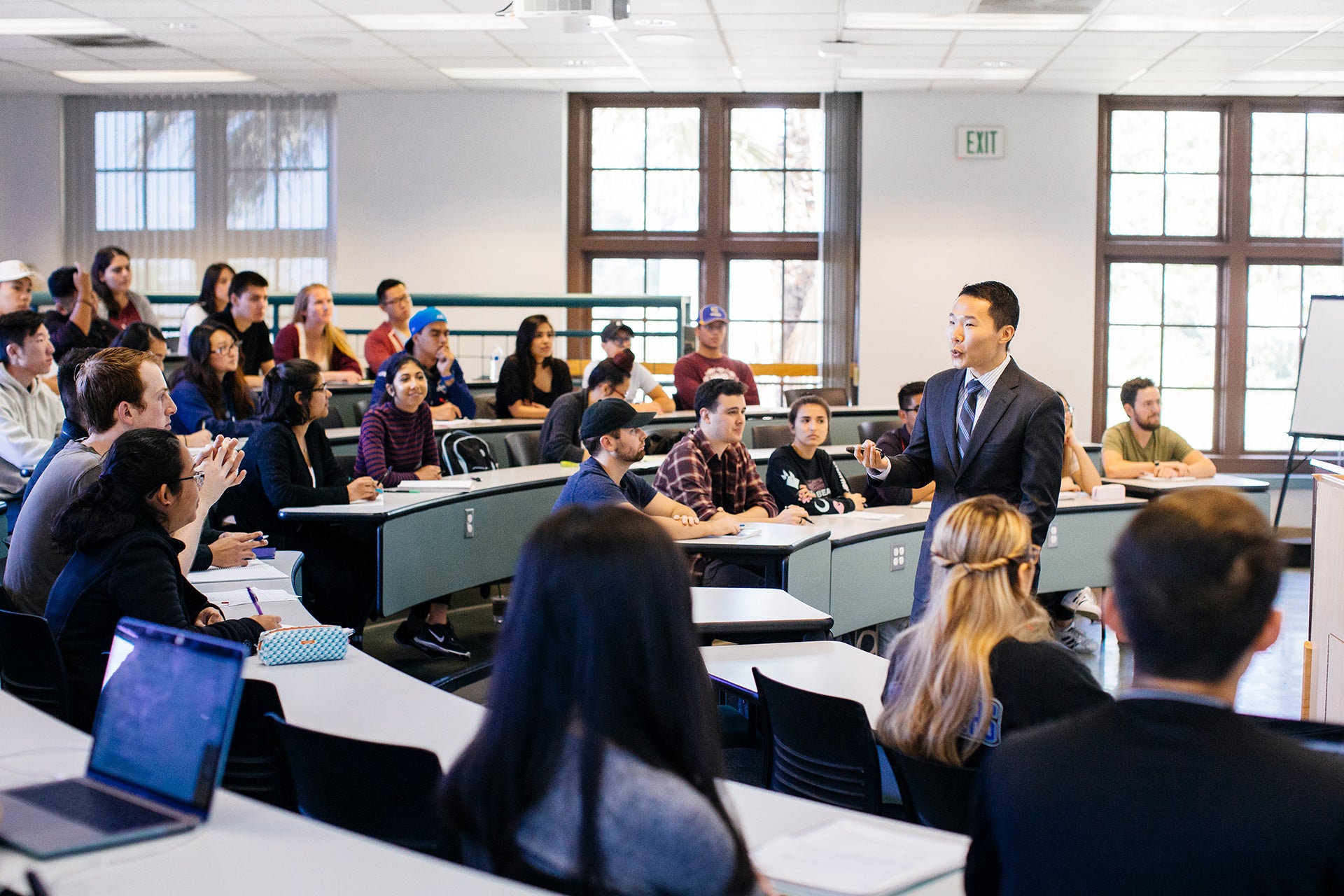 UCR faculty lecturing to class in business building